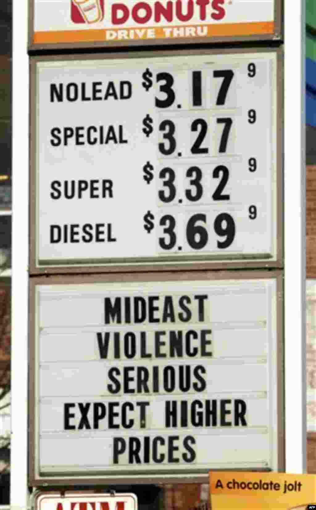 A sign advertises gas and diesel prices, plus gives an explanation to customers, at a service station in Easthampton, Mass, Wednesday, Feb. 23, 2011. Oil prices rose past $99 a barrel on Wednesday as forces loyal to Libya's Moammar Gadhafi clashed with pr