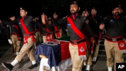 Pakistani police officers attend the funeral of their colleague Tahir Dawar in Peshawar, Pakistan, Nov. 15, 2018. 