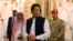 In this Tuesday, Sept. 18, 2018, photo released by the state-run Saudi Press Agency, Pakistani Prime Minister Imran Khan, center, visits the Prophet's Mosque in Medina, Saudi Arabia. Khan, a former cricketer, is on a tour of Saudi Arabia and the United Arab Emirates as part of his first overseas trip since taking office. 