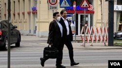 FILE - Two unidentified members of an Iranian delegation walk in Vienna on April 5, 2021, as they prepare for talks the next day aimed at reviving the 2015 Iran nuclear deal. (VOA Persian/Guita Aryan)