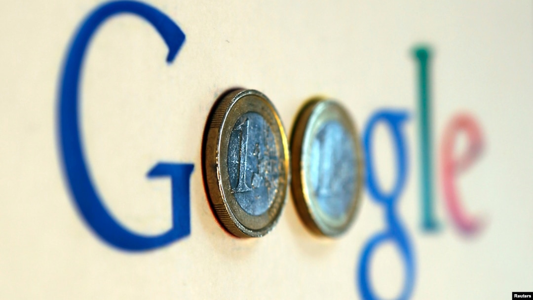 FILE - An illustration picture shows a Google logo with two one Euro coins.