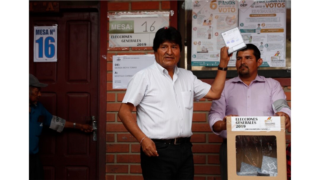Bolivia's President Evo Morales, left, poses for a picture before casting his vote in Villa 14 de Septiembre, in the Chapare region, Bolivia, Oct. 20, 2019.