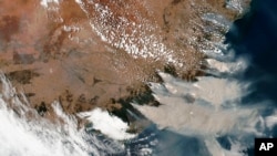 This satellite image provided by NASA on Saturday, Jan. 4, 2020 shows wildfires in Victoria and New South Wales, Australia. 