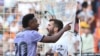 Real Madrid's Vinicius Junior, left, confronts Valencia fans in front of Valencia's Jose Luis Gaya during a Spanish La Liga soccer match between Valencia and Real Madrid, at the Mestalla stadium in Valencia, Spain, Sunday, May 21, 2023.