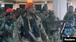 A man in military fatigues speaks as others stand next to him inside the Palace of the Nation during an attempted coup in Kinshasa, Democratic Republic of Congo, May 19, 2024 in this screen grab from a social media video. Christian Malanga/Handout via REUTERS 