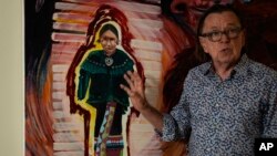 Joe Baker, a member of the Delaware Tribe of Indians and co-founder of the Lenape Center stands next to a painting of an Ohtas during an interview in his home in New York, July 18, 2024.