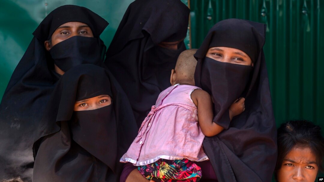 Rohingya Muslim women along with their children, who have crossed over from Myanmar into Bangladesh, wait for the arrival of Queen Rania of Jordan, at Kutupalong refugee camp in Bangladesh, Oct. 23, 2017. 