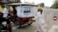 An election campaign poster of Prime Minister Hun Sen's ruling Cambodian People's Party hangs on the back of a motorized rickshaw parked at a blocked street in front of the Royal Palace in Phnom Penh.