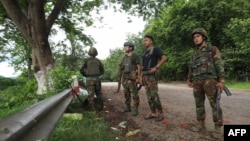 FILE - This photo taken on July 3, 2024 shows members of ethnic minority armed group Ta'ang National Liberation Army (TNLA) patrolling in Kyaukme in Myanmar's northern Shan State.