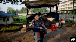 A police officer mans a roadside checkpoint in Rangoon, Burma, March 26, 2013. The government is warning that religious violence could threaten democratic reforms after anti-Muslim mobs rampaged through three Buddhist towns.