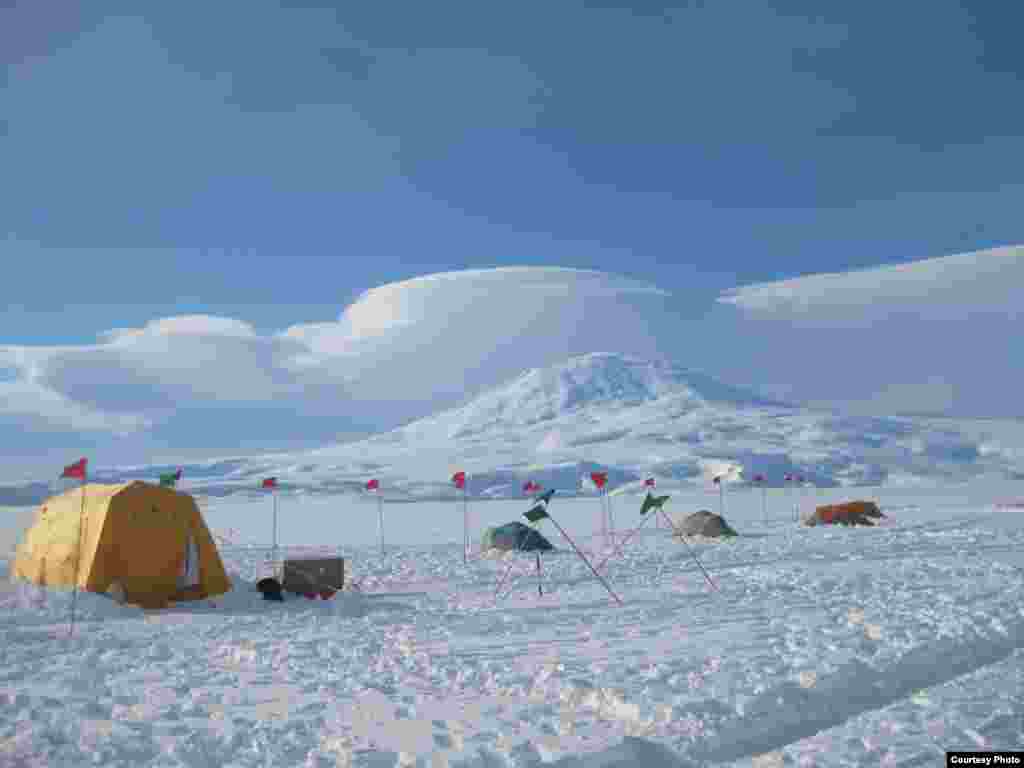 Base camp on the McMurdo Ice Shelf floats on a 200-meter- thick ice shelf, which in turn floats on the ocean which is one kilometer deep at that point. (David Holland) 
