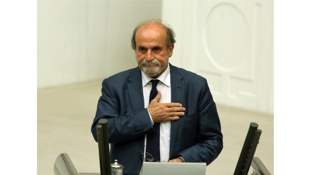 FILE - Ertugrul Kurkcu, a former leftist guerrilla and a newly elected legislator from pro-Kurdish Peoples's Democracy Party, takes his oath during the Turkish parliament's first session in Ankara, Turkey, June 23, 2015.