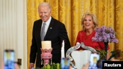 U.S. President Joe Biden and first lady Jill Biden arrive for a reception celebrating Nowruz in the East Room at the White House in Washington, March 20, 2023. 