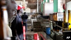 A worker monitors the bottling line at the Pampa beer factory in Bissau, Guinea-Bissau.