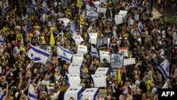 Demonstrators carry symbolic coffins during an anti-government protest to secure the release of Israeli hostages held captive since the Oct. 7 attacks by Palestinian militants in the Gaza Strip, in front of the Israeli Defense Ministry in Tel Aviv on Sept. 5, 2024