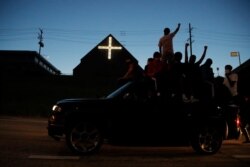 Protesters move along a highway, May 29, 2020, in Minneapolis.