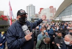 FILE - Blogger Sergei Tikhanovsky speaks during a rally of supporters of opposition politicians amid the coronavirus pandemic, in Minsk, Belarus May 24, 2020.