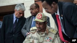 Gen. Mohammed Hamdan Dagalo signs a power sharing document with Sudan's pro-democracy movement and the ruling military council in Khartoum, Sudan, Wednesday, July 17, 2019. 