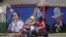 A motorcyclist rides past a mural of Nicaraguan President Daniel Ortega, left, and revolutionary hero Cesar Augusto Sandino during general elections in Managua, Nicaragua, Nov. 7, 2021.