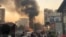 Smoke rises following a bomb explosion in Kabul, Afghanistan, Saturday, Nov. 13, 2021. Emergency workers say a bomb exploded on a minibus on a busy commercial street in a Kabul neighborhood populated by the Hazara community.