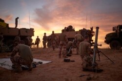 FILE - Soldiers from the French Army set up a Temporary Operative Advanced Base during the Bourgou IV operation in the area of the three borders between Mali, Burkina Faso and Niger, Nov. 9,2019.