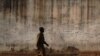 FILE - A prison guard walks along a perimeter wall at a prison in Rumbek, Lakes state, South Sudan, Feb. 19, 2014. Supporters are calling for the release of 32 prisoners detained in South Sudan allegedly for opposing the government of President Salva Kiir.