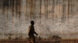 FILE - A prison guard walks along a perimeter wall at a prison in Rumbek, Lakes state, South Sudan, Feb. 19, 2014. Supporters are calling for the release of 32 prisoners detained in South Sudan allegedly for opposing the government of President Salva Kiir.