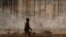 FILE - A prison guard walks along a perimeter wall at a prison in Rumbek, Lakes state, South Sudan, Feb. 19, 2014. Supporters are calling for the release of 32 prisoners detained in South Sudan allegedly for opposing the government of President Salva Kiir.