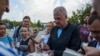 U.S. historian and author Timothy Snyder gives autographs on his books before a charity run to raise awareness of Ukrainian prisoners of war held by Russia, in Kyiv, Ukraine, on Sept. 14, 2024.