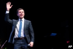 Democratic presidential candidate Pete Buttigieg waves to the crowd during a town hall meeting, in Concord, New Hampshire, Feb. 5, 2020.