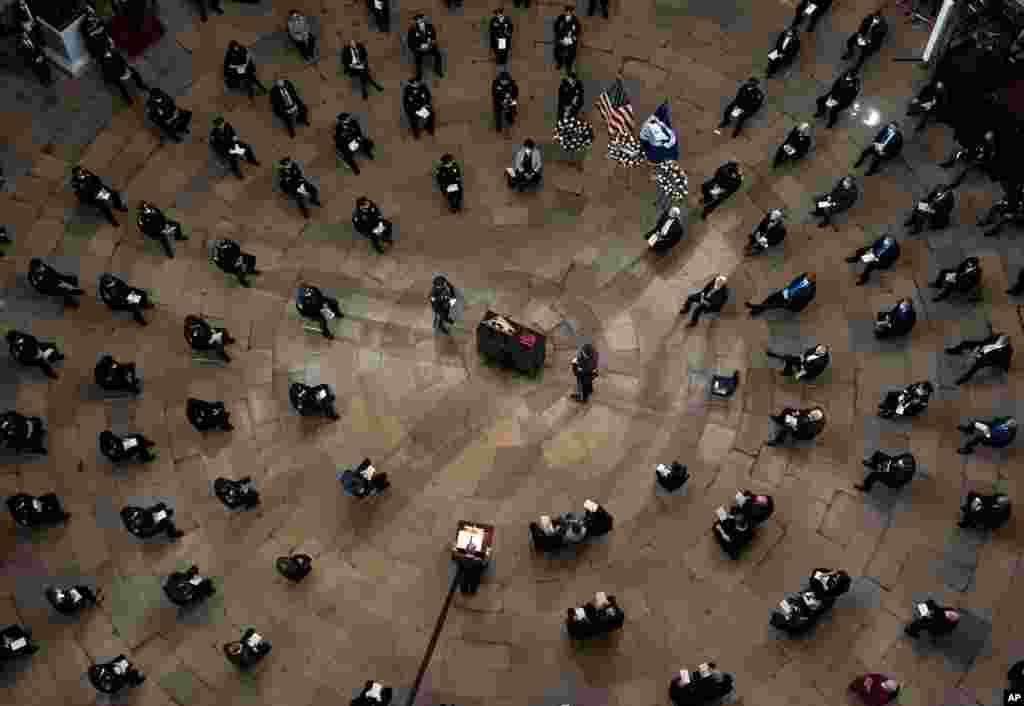 Senate Majority Leader Chuck Schumer of N.Y., speaks during a ceremony memorializing U.S. Capitol Police officer Brian Sicknick, as an urn with his cremated remains lies in honor on a black-draped table at the center of the Capitol Rotunda in Washington.