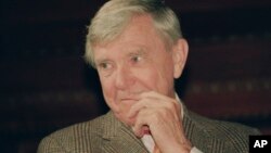 FILE - Writer Russell Baker ponders a reporter's question during a New York news conference where he was presented as the successor to host Alistair Cooke for the PBS series "Masterpiece Theatre," Feb. 23, 1993.