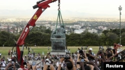 Students cheer as the statue of Cecil John Rhodes is removed from the University of Cape Town (UCT) in South Africa, April 9, 2015. 