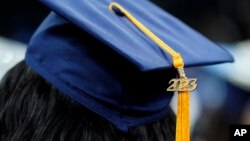 FILE - A tassel with 2023 on it rests on a graduation cap as students walk in a procession for Howard University's commencement in Washington, May 13, 2023. 