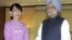 India's Prime Minister Manmohan Singh (R) shakes hands with Burma pro-democracy leader Aung San Suu Kyi during their meeting in Rangoon, May 29, 2012.