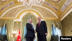 Russian President Vladimir Putin, left, shakes hands with Turkey's President Recep Tayyip Erdogan during their meeting in the Kremlin in Moscow, March 10, 2017.