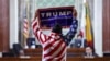 FILE - protester holds a Trump sign at City Hall as the Los Angeles City Council meets to consider adopting a "Sanctuary City'' ordinance in Los Angeles, California, November 19, 2024. 