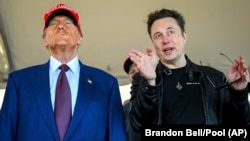 FILE - President-elect Donald Trump, left, listens to Elon Musk as he arrives to watch SpaceX's mega rocket Starship lift off from Starbase in Boca Chica, Texas, Nov. 19, 2024. On Saturday, Trump said he backs the H-1B visa program for foreign tech workers. (Brandon Bell/Pool)