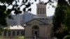 FILE - A man walks by Hamerschlag Hall on the Carnegie Mellon University campus in Pittsburgh, June 7, 2019, 