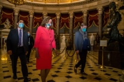House Speaker Nancy Pelosi walks towards the House Chamber at the Capitol, July 20, 2020, in Washington. Pelosi, who presided over a moment of silence for Georgia Rep. John Lewis, choked up recalling their last conversation the day before he died.