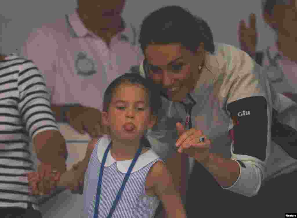 Britain&#39;s Princess Charlotte sticks her tongue out next to her mother, Catherine, Duchess of Cambridge, before a presentation ceremony following the King&#39;s Cup Regatta in Isle of Wight.