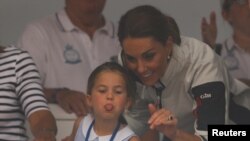 Britain's Princess Charlotte sticks her tongue out next to her mother, Catherine, Duchess of Cambridge, before a presentation ceremony following the King's Cup Regatta in Isle of Wight.