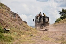 Armenian servicemen transport used tires in the back of a truck to fortify their positions on the Armenian-Azerbaijani border near the village of Movses on July 15, 2020.