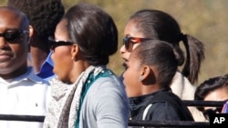 Michelle Obama, left, and her daughters react to seeing an elephant on a safari in South Africa, June 25, 2011
