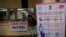 An Indian man with symptoms fills a form at a Corona virus help desk at the Government Gandhi Hospital in Hyderabad, India, March 2, 2020.