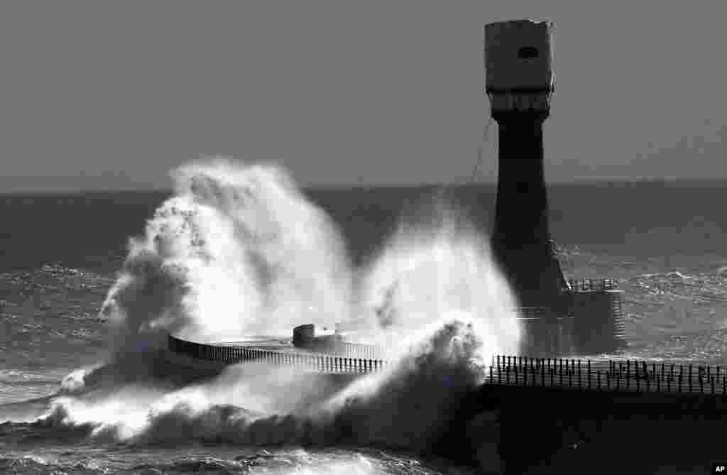 Heavy waves crash over Roker pier at Sunderland, England. 