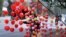 A vendor arranges heart-shaped balloons along the roadside to attract customers ahead of Valentine's Day, in Lahore, Pakistan, Feb. 13, 2016.