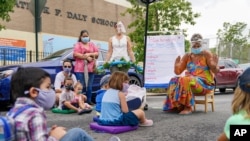 Preschool teacher Mikki Laugier and students participate in an outdoor learning demonstration to display methods schools can use during the coronavirus pandemic, Sept. 2, 2020, at P.S. 15 in the Brooklyn borough of New York.