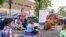 Preschool teacher Mikki Laugier and students participate in an outdoor learning demonstration to display methods schools can use during the coronavirus pandemic, Sept. 2, 2020, at P.S. 15 in the Brooklyn borough of New York.
