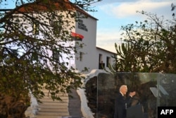 The Angolan flag flutters as U.S. President Joe Biden speaks during his visit to the National Slavery Museum in Morro da Cruz, near Luanda, on Dec. 3, 2024.